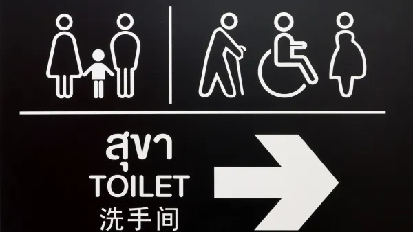 White on black restroom sign with symbols and text in Thai.