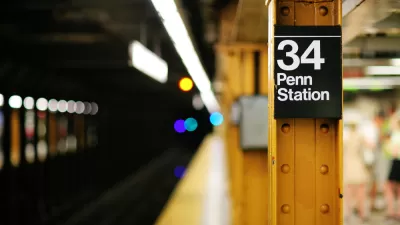 Close-up of yellow steel column on subway platform with sign: "34 Penn Station"