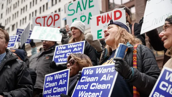 Protesters holding signs calling for clean air and water. 