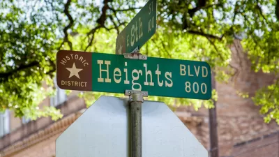 Close-up of green street sign at Heights Blvd and 8th Street in Houston, Texas with "Historic District" and star logo