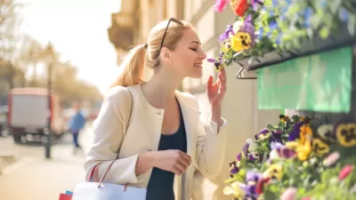 Woman smelling flowers at a street stand