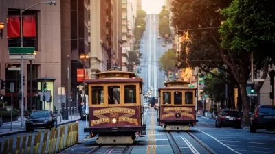 Historic cable cars on California Street in San Francisco, California with hill and city buildings in background