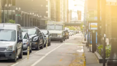 Bike lane and line of cars on street in Chicago with sun in background