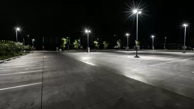 Asphalt parking lot at night with bright lights