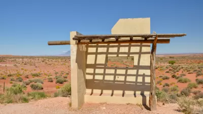 Adobe and wood bus stop shelter on deserted road in Navajo Nation