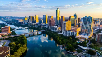 Aerial view at dusk of downtown Austin, Texas with river in foreground