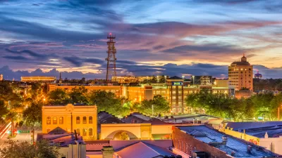Gainesville, Florida skyline with tall water tower against cloudy sunset sky