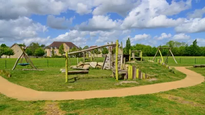 Children's playground in a London park with a green lawn
