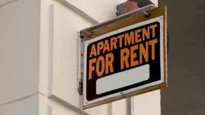 "Apartment for Rent" sign installed perpendicularly on a while building wall