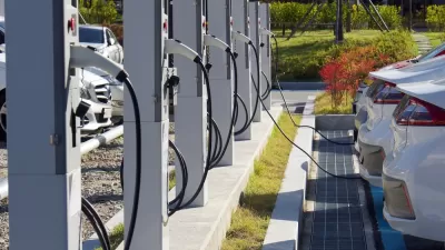 Electric vehicle charging station with white cars plugged in