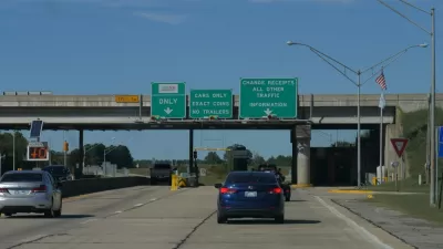View of cars on Oklahoma road with green signs signaling tolls ahead