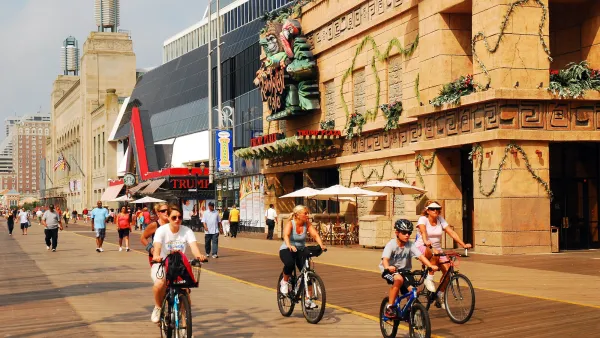 People riding bikes onboardwalk in Atlantic City, New Jersey.
