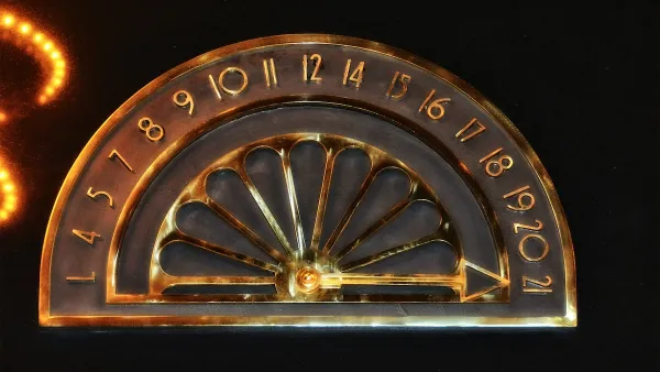Close-up on gold vintage elevator indicator with 21 floors and 13th floor missing.