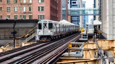 CHicago elevated train passing by brick buildings