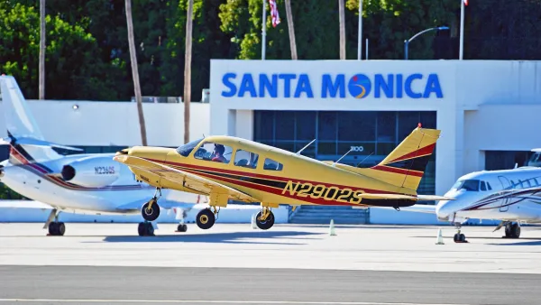 Yellow and white small planes on tarmac at Santa Monica Airport.