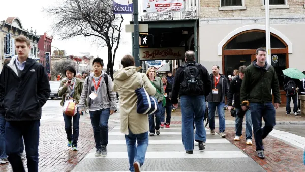 Busy crosswalk with pedestrians on small street in Austin, Texas.