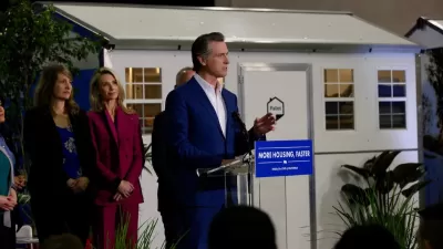 California Governor Gavin Newsom announcing funding for tiny home shelter project in front of quick-build tiny home shelter unit.