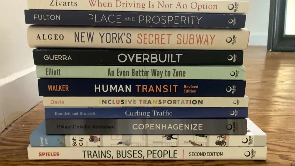 Stack pf urban planning books on table.
