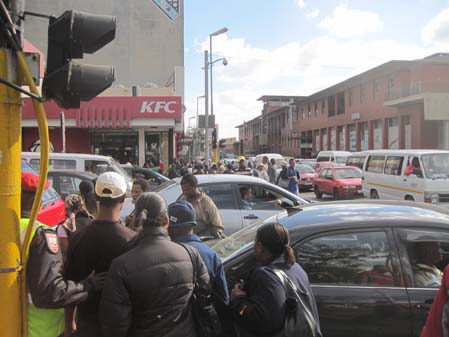 Pedestrians Struggling Through Joburg Traffic