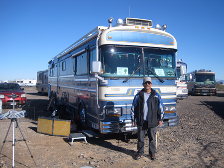 Rally organizer Phil Corpus stands in front of his home on wheels.